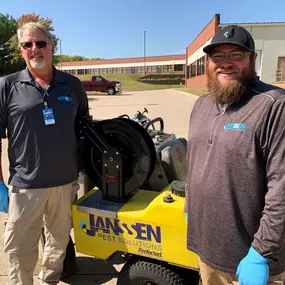 Janssen Pest Solutions technicians outside commercial property in Des Moines, Iowa.