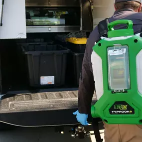 Janssen Pest Solutions technician wearing a bug treatment straying machine.