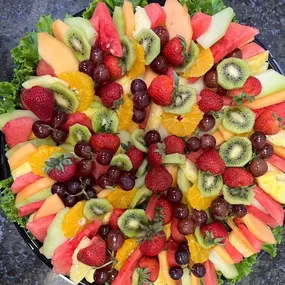 A colorful fruit platter with fresh strawberries, pineapple, and melon slices arranged by Cranberry Hills Eatery & Catering is perfect for breakfast events or catering in Phoenix.