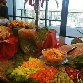 Cranberry Hills Eatery & Catering in Phoenix offers catering options that include a vibrant fruit display with watermelon carvings and tropical arrangements.