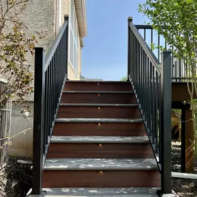 Composite deck stairs with deck lighting and black railings