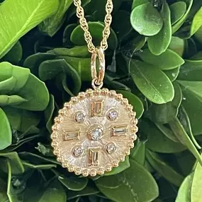 Beautiful gold and diamond medallion. Perfect for layering or a show stopper worn alone. Come see us!