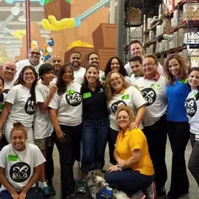 Leads group volunteering at Second Harvest Food Bank, making boxes of food and delivering them to families in need.