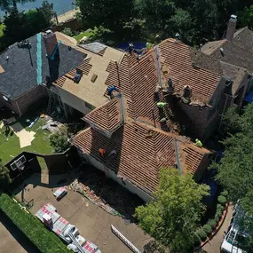 Aerial view of home being fully renovated with a new tile roof
