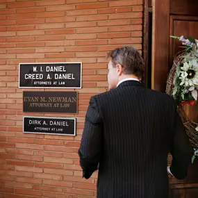 Evan Newman at the office entrance of Daniel, Daniel and Newman