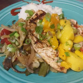 Caribbean jerked chicken finished with a butter rum sauce. Served with jasmine rice, house vegetables and pineapple salsa.