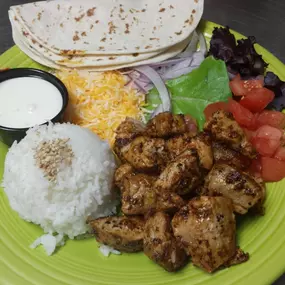 Blackened Tuna Tacos with cheese, lettuce, onions, tomatoes and lime sour cream.