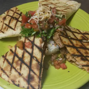 Blackened Tuna Quesadilla with rice and black beans. Topped with Pico de gallo.