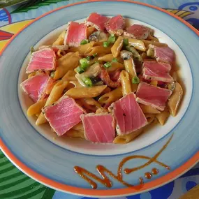 Special Occasion Pasta with Tuna - Penne pasta sautéed with roasted red peppers, sugar snap peas, scallions, and mushrooms, in a creamy soy sauce reduction. Our most popular pasta dish!