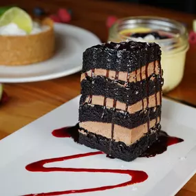 Seven Layer Chocolate Cake with hot fudge, Maldon sea salt, and raspberry coulis.