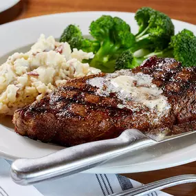 12oz New York Strip with bone marrow butter, seasonal vegetable, and garlic mashed potatoes.