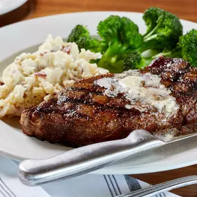 12oz New York Strip with bone marrow butter, seasonal vegetable, and garlic mashed potatoes.