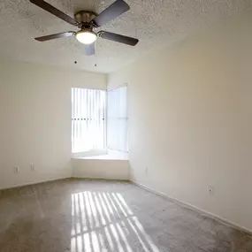 Apartment Interior with Corner Windows and Ceiling Fan