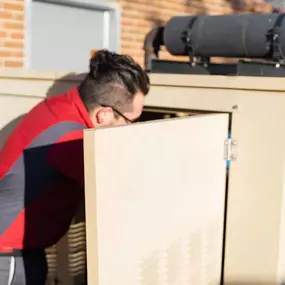 tech fixing a generator