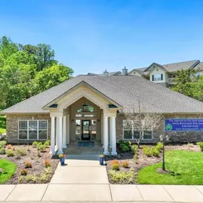 The leasing office building with well-manicured landscaping at The Legends on the Park.