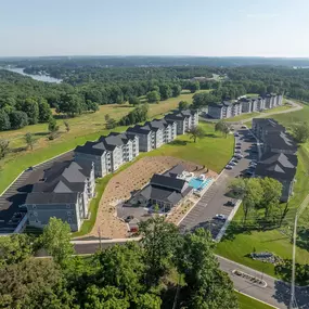 A bird's eye view of a residential area with multiple houses and a swimming pool.