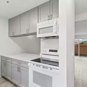 A modern kitchen with white appliances and cabinets