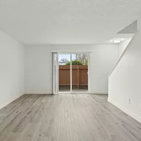 A room with a wooden floor and white walls