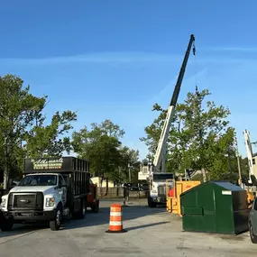 Crane lift for commercial dumpster placement in the Outer Banks.