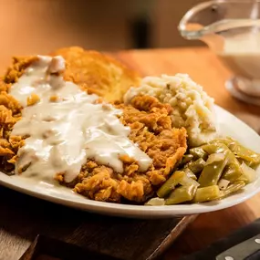 Country Fried Steak: Hand-breaded on Texas toast with gravy. Served with two sides.