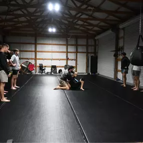 Coach Luke and Natasha teaching a Jiu Jitsu Group Class