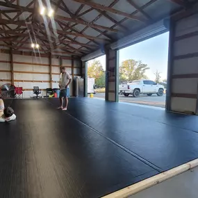 Coach luke giving a private Jiu Jitsu lesson to a father and son