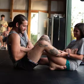 A male and female couple training jiu jitsu drills