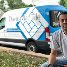 The Davie Mac Tile work van parked outside a residential property, branding in full display.