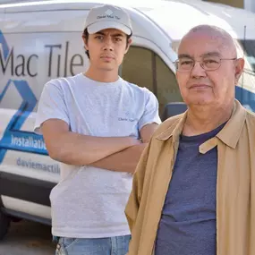 Two men standing confidently in front of a Davie Mac Tile van, showcasing professionalism and teamwork.