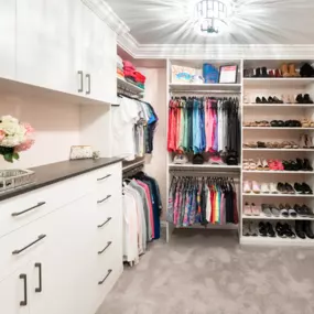 Custom closet with white finish and chocolate accents.