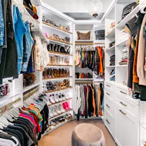slanted shoe shelves with a matte gold rail system