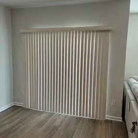 Vertical blinds is still the gold standard for covering large glass sliding doors.  It lets warm diffused light into the room if tilted a little, or can be fully opened or closed.  These solid vinyl vanes make it scratch-proof, important if you live with any 4-legged creatures!