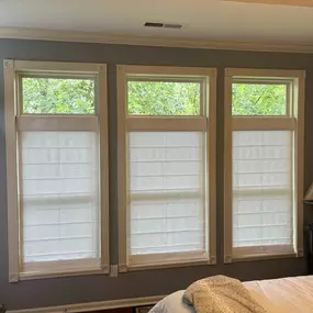 Floating Roman shades look elegant on tall windows with traditional window frames.