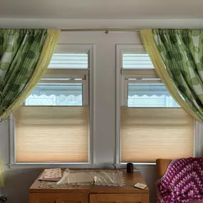 Lightly-colored top-down bottom-up cellular shades make a great match to accented drapes.