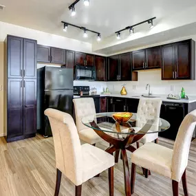 Kitchen with dark wood cabinets and dining area
