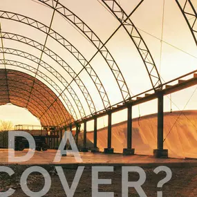 Marketing image from Pilot Buildings featuring a partially covered arched structure during installation at sunset, with the text 