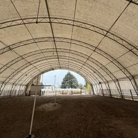 This 27-year-old arena highlights the durability of fabric structures. Pilot Buildings offers re-covering services using modern HDPE fabric with a 20-year warranty to revitalize older buildings, enhancing appearance and performance.