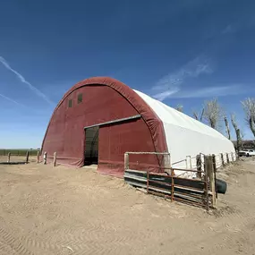 View the completed transformation by Pilot Buildings. This revitalized fabric arena features a brand new, durable HDPE cover (red end wall, white roof/sides), ensuring longevity and performance for years to come. Contact us for building re-covers.
