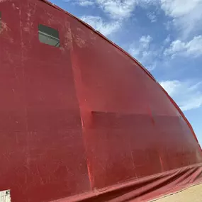 Detailing the quality finish of a Pilot Buildings re-covering project. This revitalized fabric arena uses durable, warrantied HDPE fabric for long-lasting performance and appearance. Contact us to restore your building.