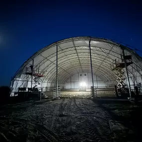 Pilot Buildings works diligently to complete re-covering projects efficiently. This view shows progress on the 27-year-old arena's renovation, which features durable HDPE fabric, including custom red end walls.
