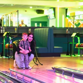 Mum on bowling lane with son