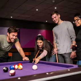 Friends playing pool