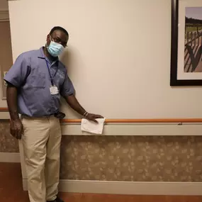 Shaker Place Rehabilitation and Nursing Center Employee cleaning hallway