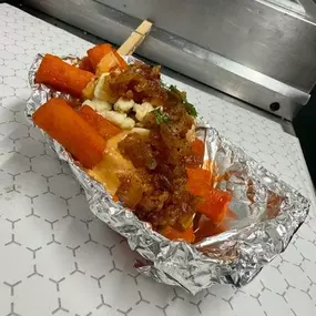 “HotToGo” Fries! Loaded fries tossed in our House Roasted Pepper Sauce with bacon jam, Slap Sauce, and Blue cheese crumble.