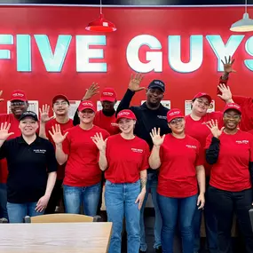 Crew members pose for a photograph inside the dining room ahead of the grand opening of the Five Guys restaurant at 601 Harry L Drive in Johnson City, New York.