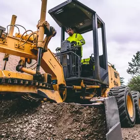 PLM Paving and Concrete employee operating an excavator