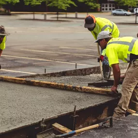 PLM Paving and Concrete employees leveling out concrete