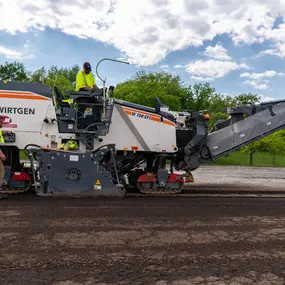 PLM Paving employees on a cold planer machine