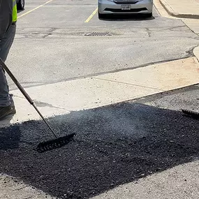 PLM Paving employees patching up a pothole