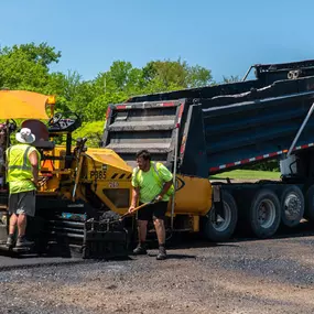 plm paving employees shoveling asphalt